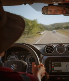 person driving car on road during daytime